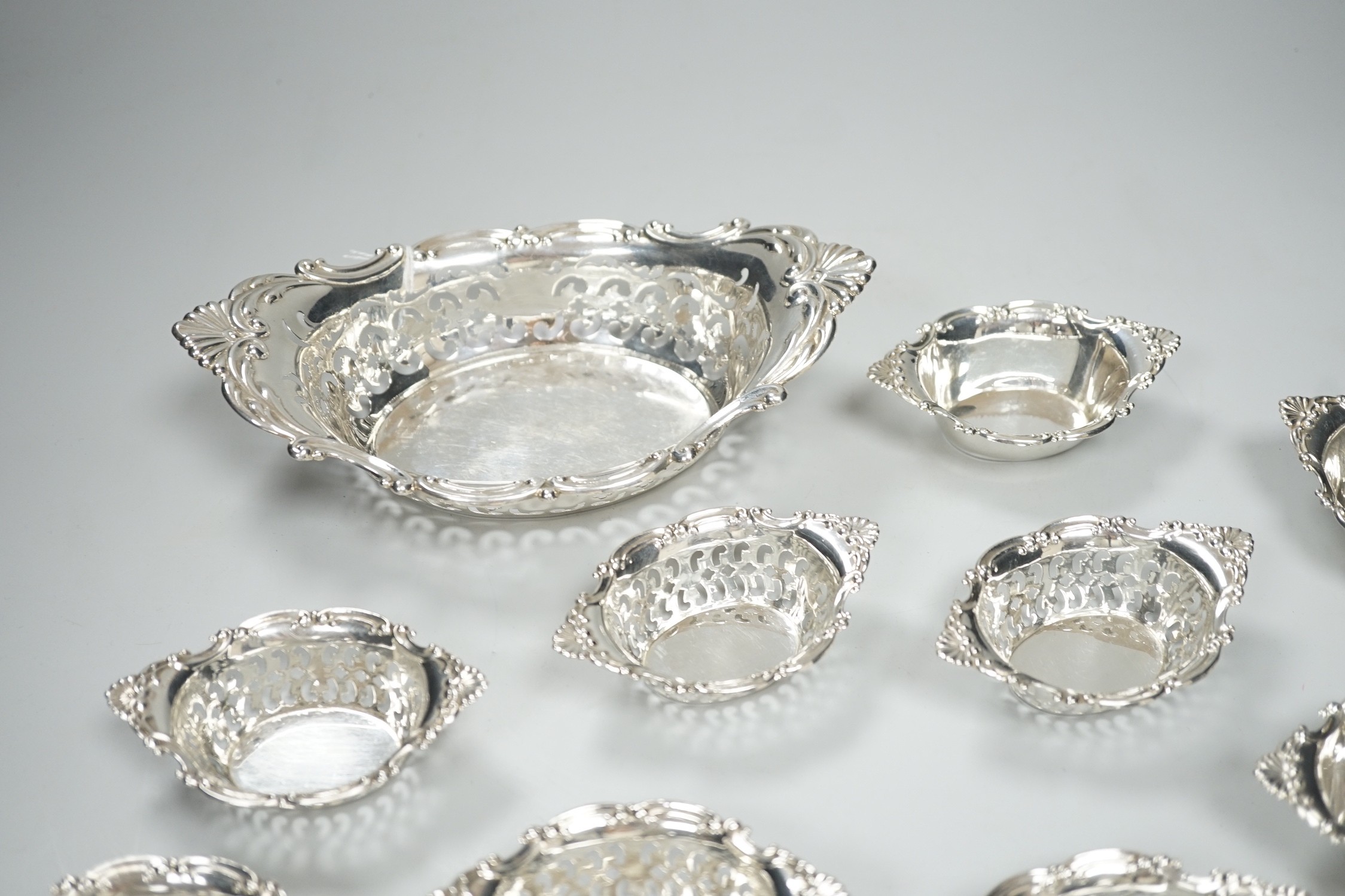 A set of ten Canadian Birks pierced sterling nut dishes, 97mm and a similar larger dish, 20.8cm, 11oz.